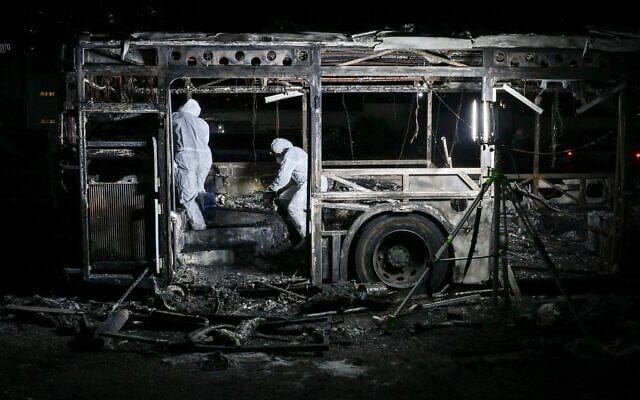 Security forces probe a bus targeted by an explosive device, in Bat Yam, February 20, 2025. (Avshalom Sassoni/Flash90)