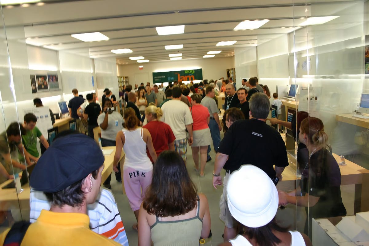 The interior of Apple The Pier as pictured from the entrance on grand opening day. The store is filled with people.