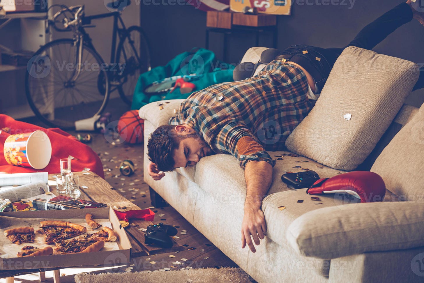 When the party is over. Young handsome man passed out on sofa in messy room  after party 13577700 Stock Photo at Vecteezy