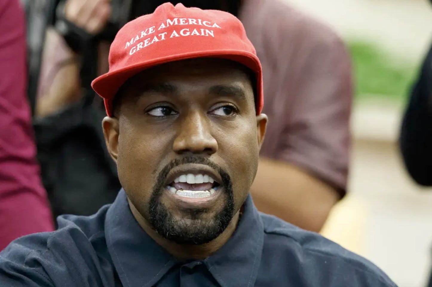 Kanye West with a MAGA hat on his head