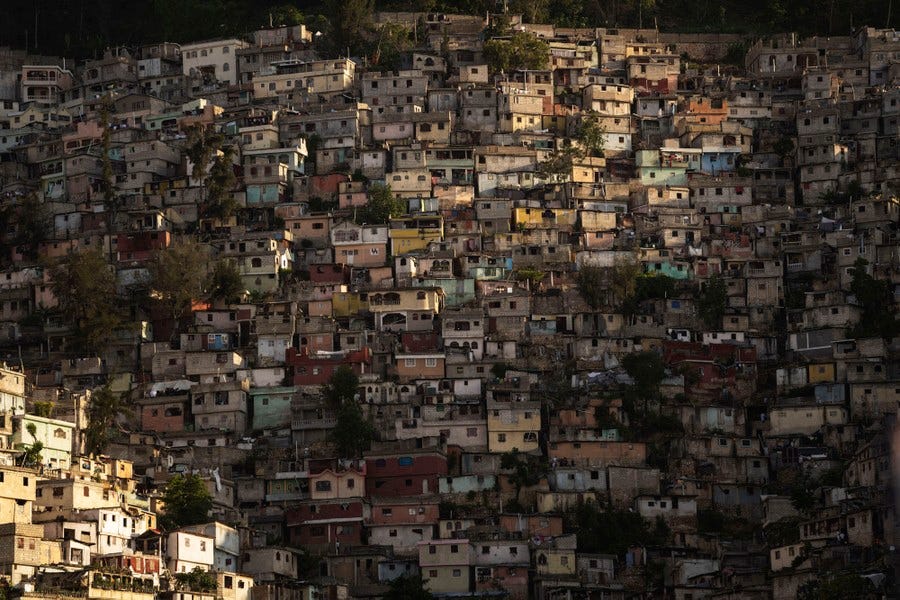 Closely built small houses cover a hillside in Haiti.
