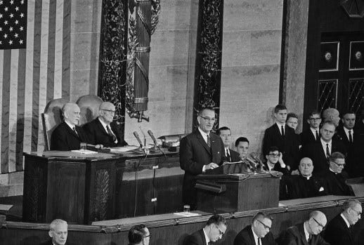 President Lyndon B. Johnson delivers his State of the Union address to a joint session of Congress, Jan. 8, 1964. Speaking in the House of Representatives, the chief executive said on eof his aims was “unconditional war on poverty in America.” In background from left are: Speaker John McCormack of Massachusetts and Sen. Carl Hayden of Arizona.  (AP Photo)
