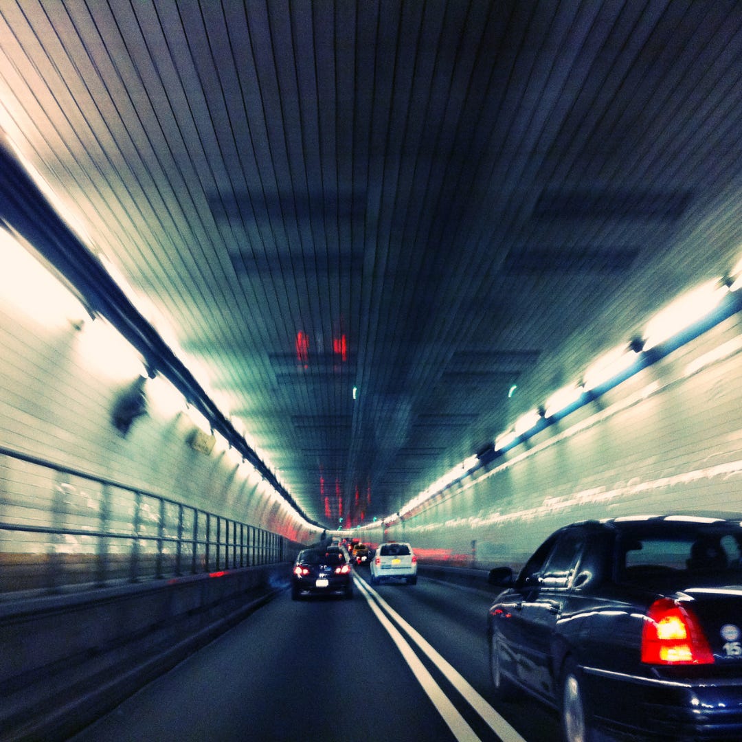 the view inside an underground tunnel filled with traffic