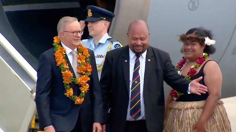 Australian Prime Minister Anthony Albanese, left, is greeted on his arrival at an airport in Port Moresby, Papua New Guinea.