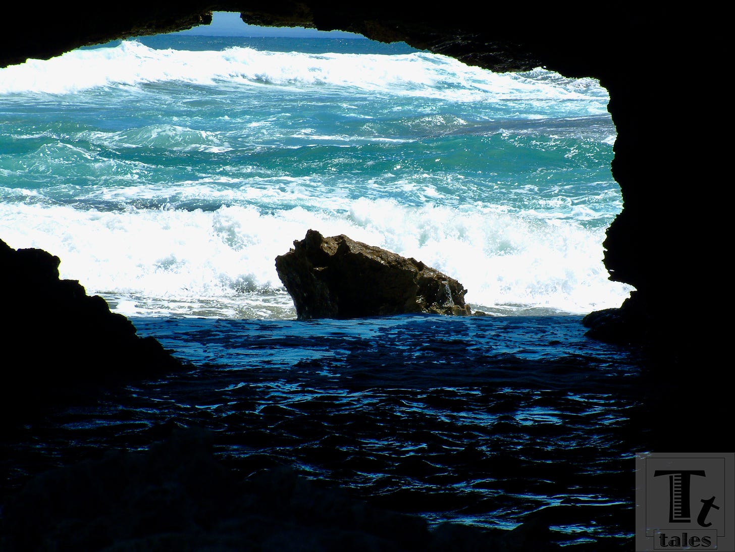 Boiling surf viewed from inside a dark cave
