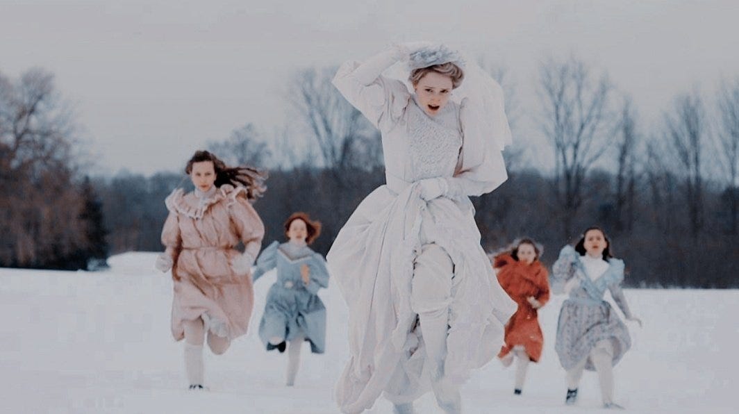 Five girls in 1890s attire running down a snow-covered plain