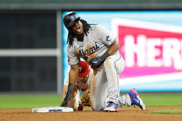 Josh Bell of the Miami Marlins reacts after hitting a double during the ninth inning against the Philadelphia Phillies in Game One of the Wild Card...