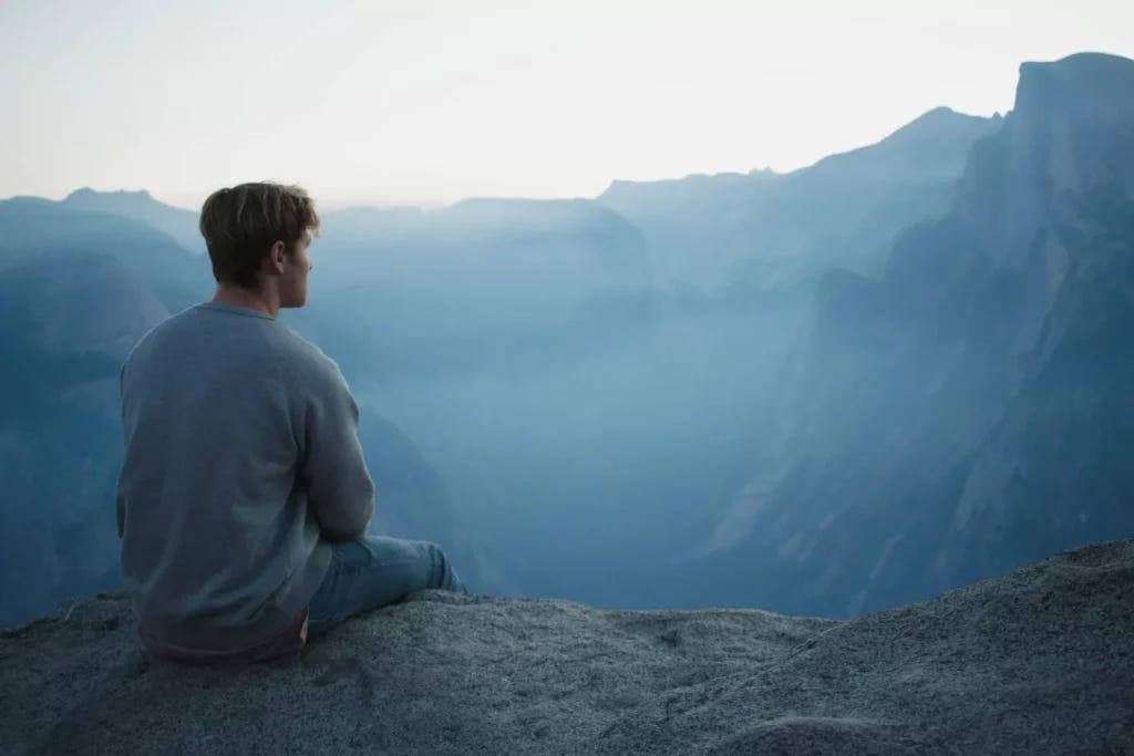best meditation music, man meditating on a mountain