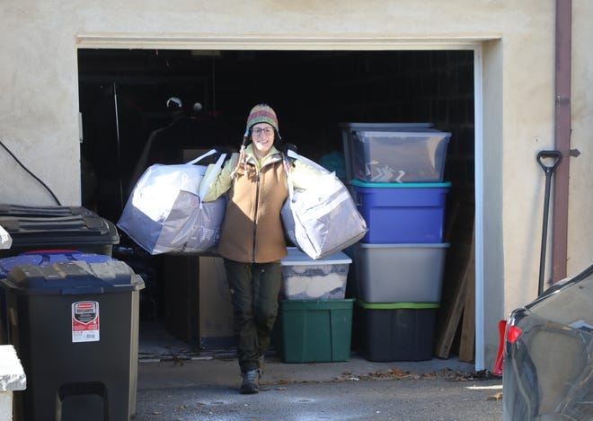 Rachel Tanzola-Sullivan carries clothing to a rental truck on Jan. 21, 2022. The donated winter items were distributed in the Bronx.