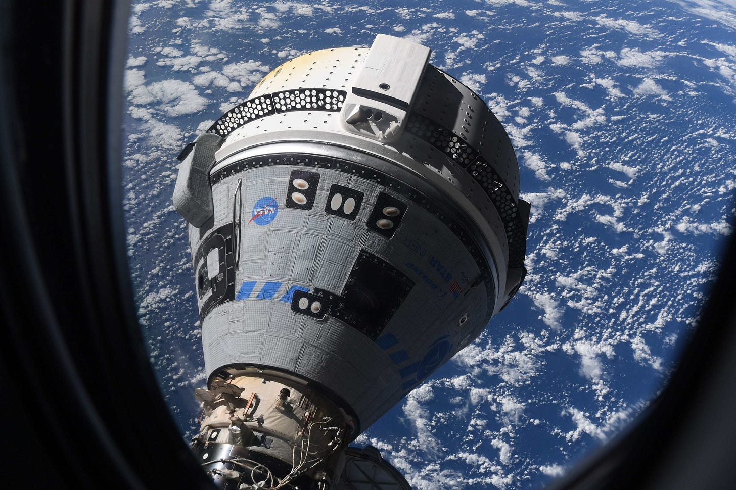 https://boeing-jtti.s3.amazonaws.com/wp-content/uploads/2023/02/13165520/docking_with_earth_in_background_out_window.png