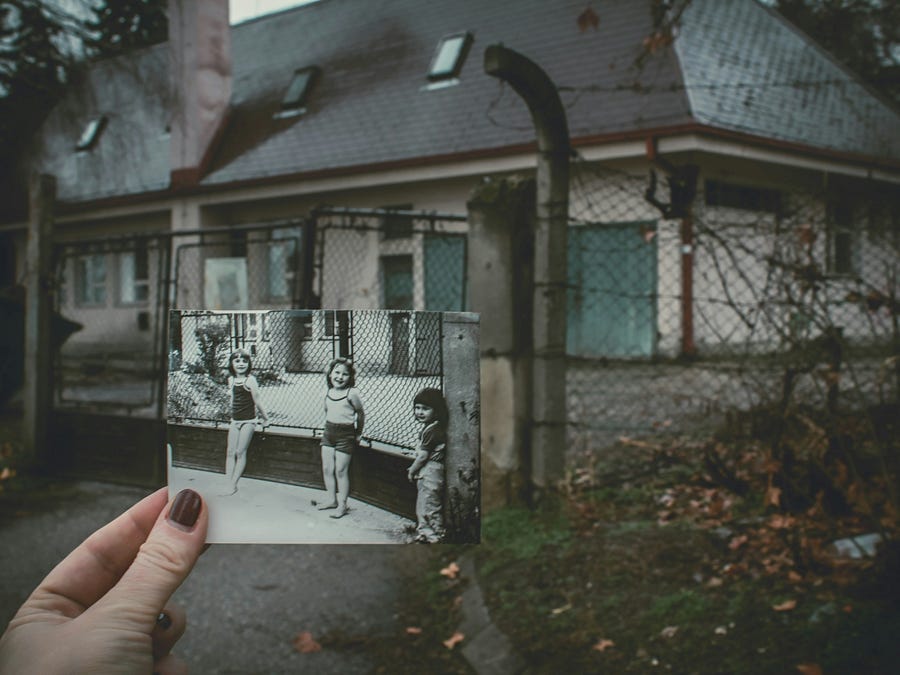 An old photo of children in fornt of a house An old photo of children in fornt of a house