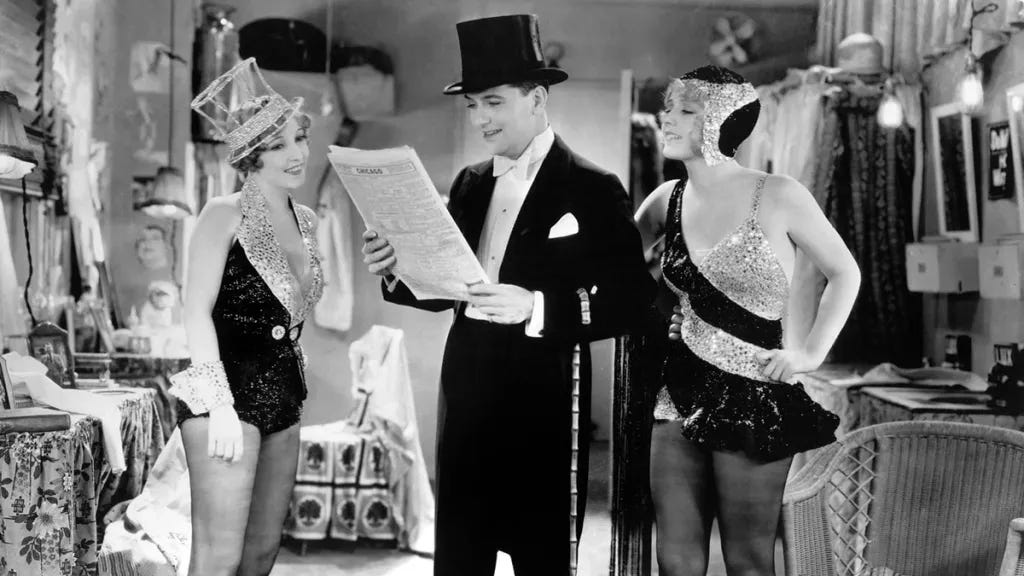 Bessie Love, Kenneth Thomson, and Anita Page in a scene from The Broadway Melody