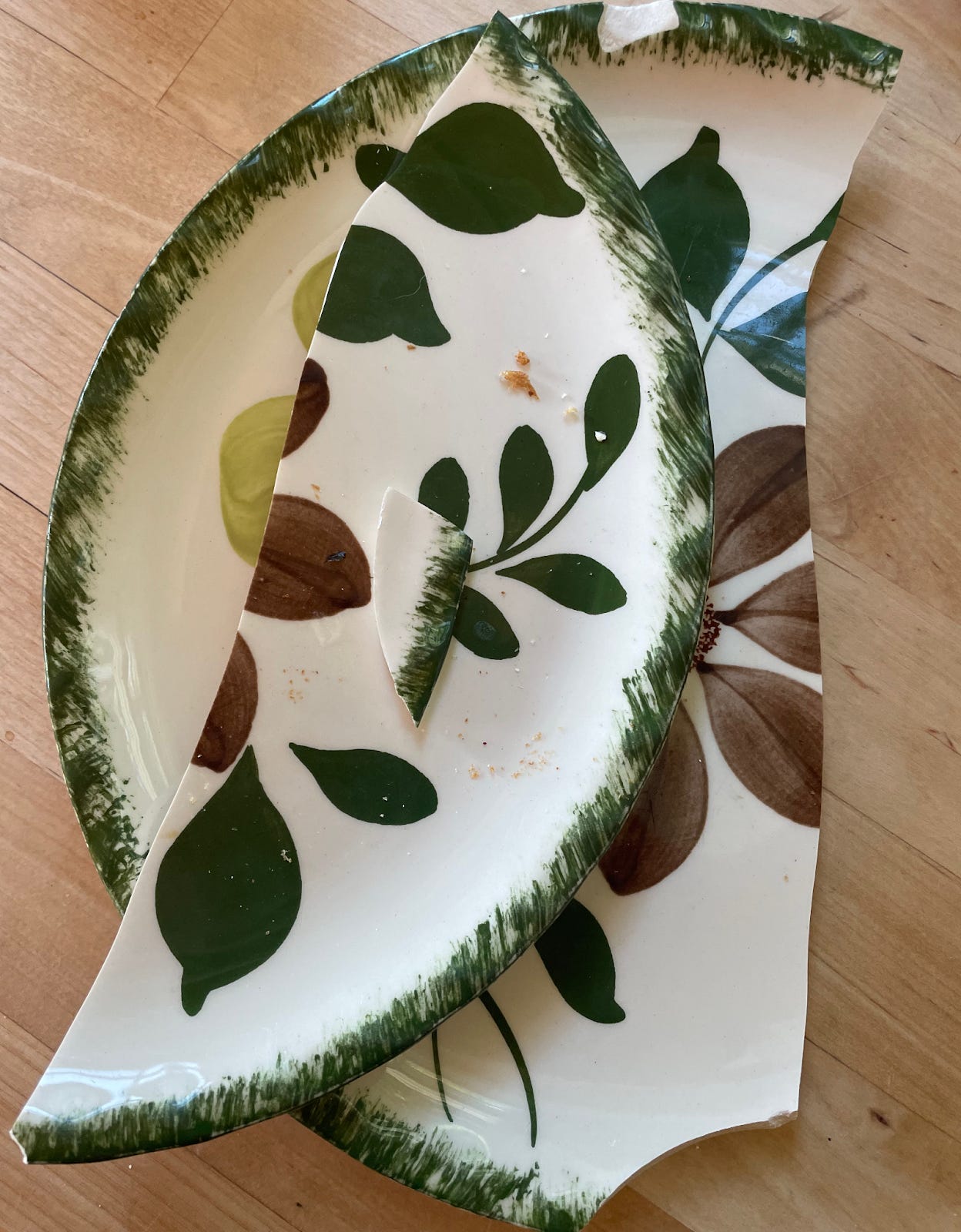 broken plate with grean border and floral pattern