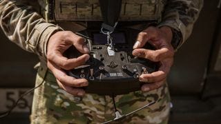 A soldier holding a drone