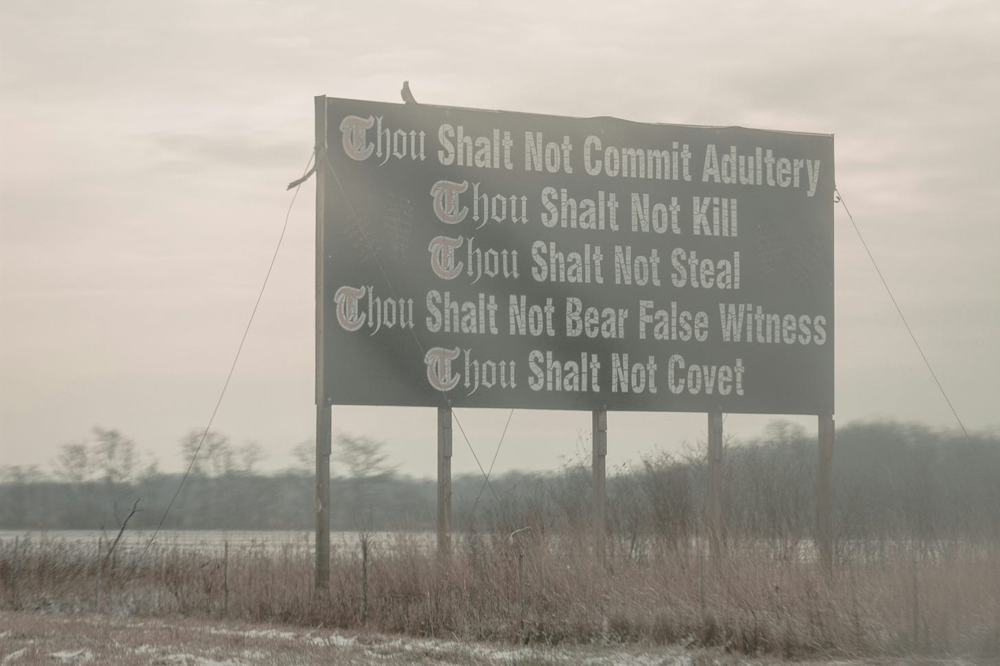 Billboard by weedy highway with the 5 "thou shalt not" commandments