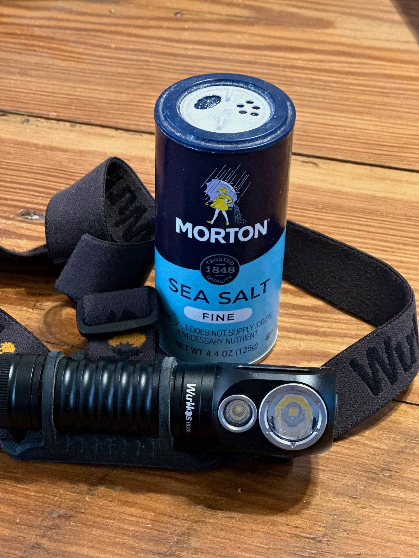 A headlamp and a can of salt

Description automatically generated