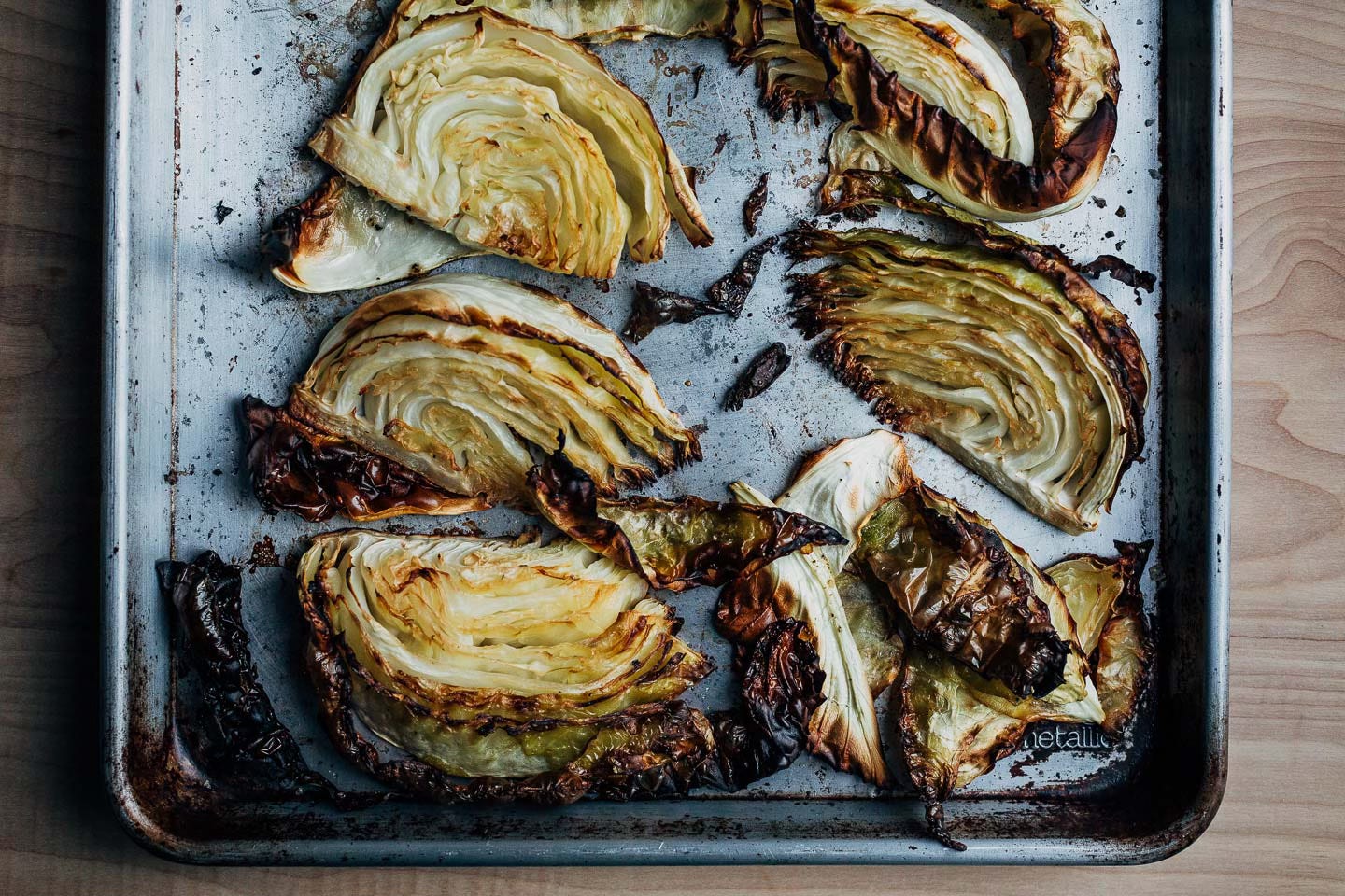 Roasted cabbage on a baking sheet.