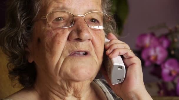 Old retired woman talking on phone Stock Video Footage by ©kagemusha  #19592005