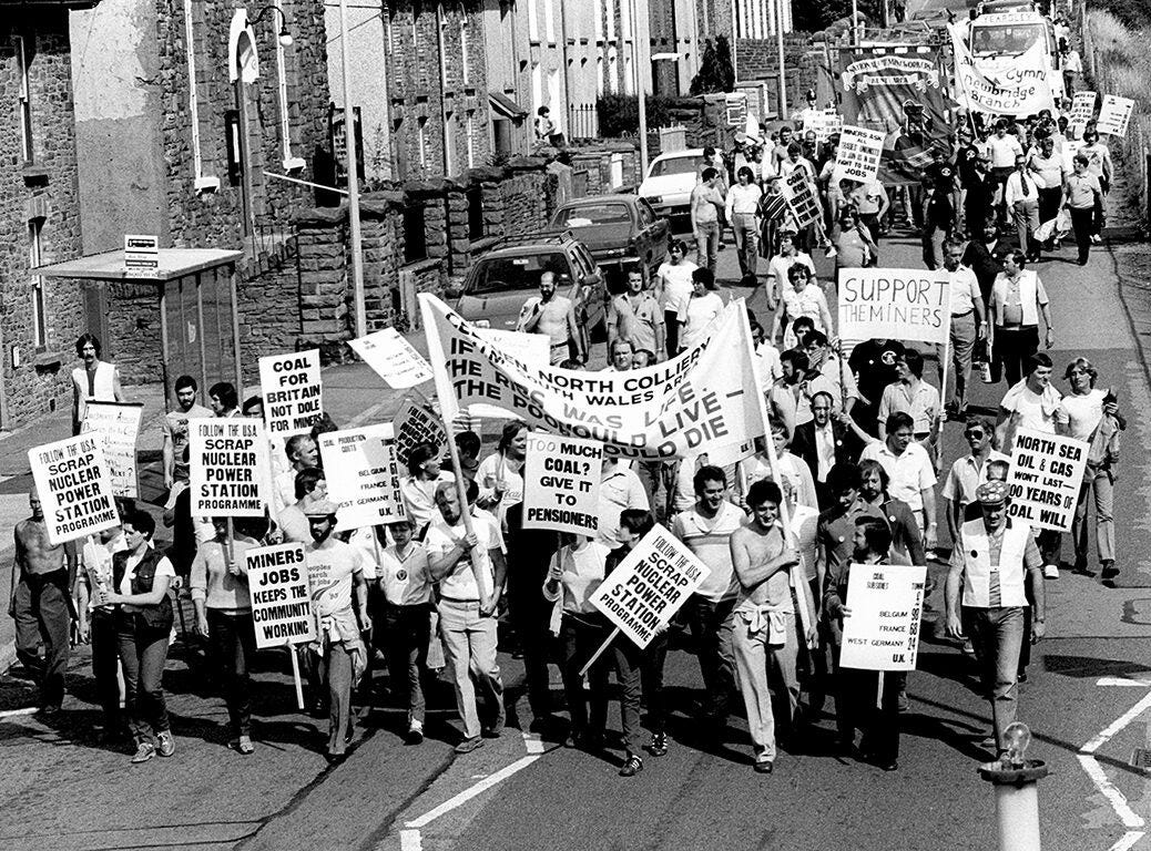 Photo shows miners from Celynen North Colliery with their familes and supporters marching with banners during the 1984 miners strike.