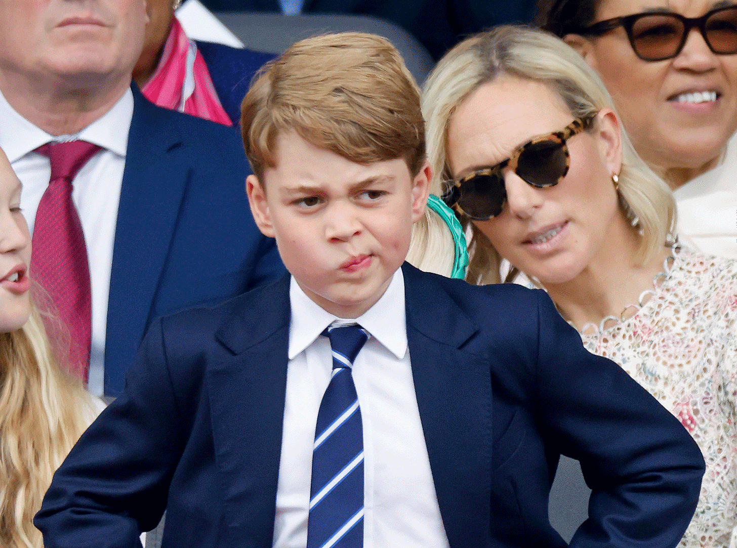 prince george looking quizzical wearing a suit