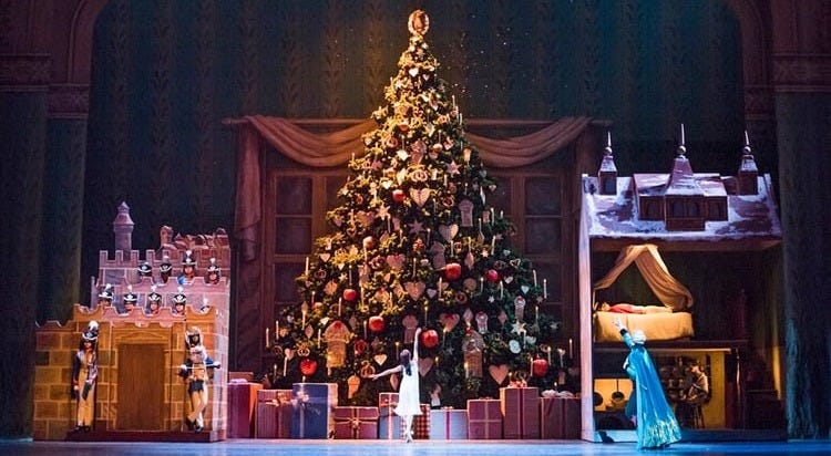 stage set for the Nutcracker ballet with huge Christmas tree and dancers