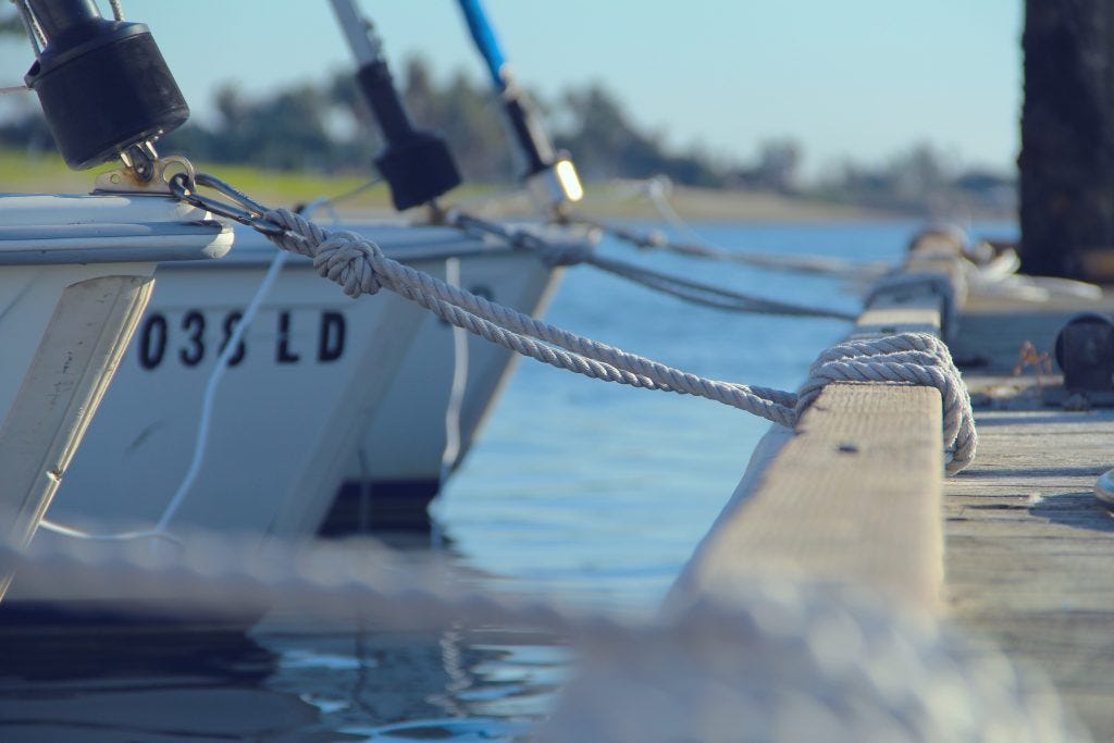 Boats tied up on a dock.