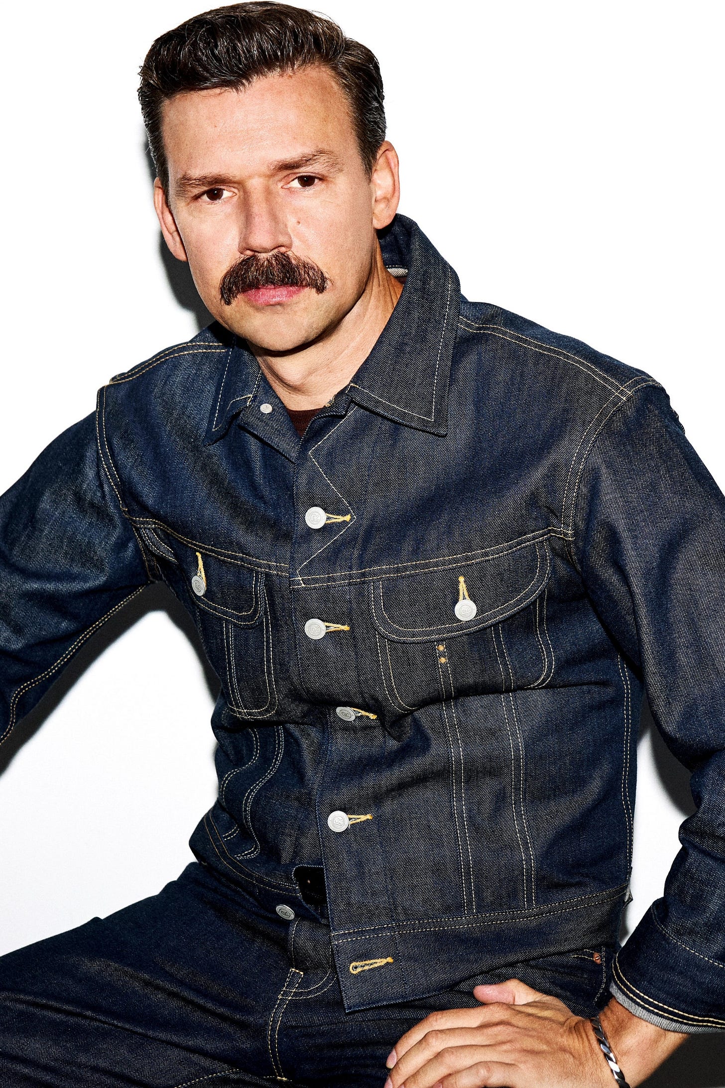 Image may contain Danny Burstein Clothing Pants Coat Jacket Jeans Adult Person Accessories Bracelet and Jewelry