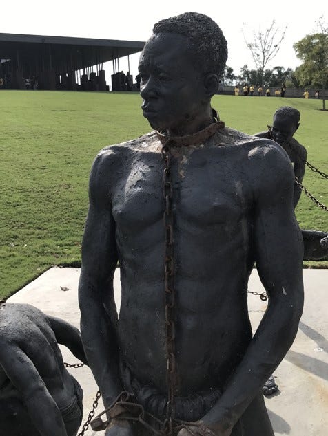 A statue of a person with chains

Description automatically generated
