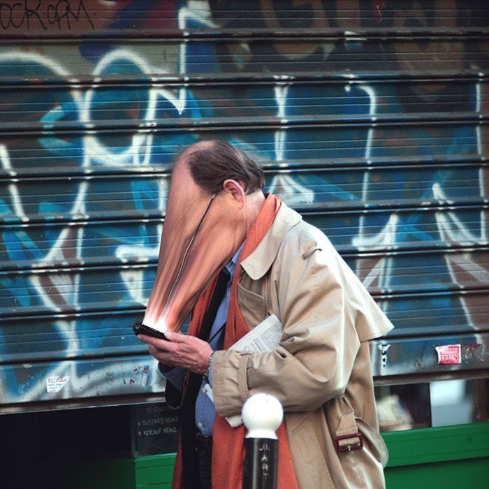 This may contain: a man standing next to a building with graffiti on it's walls and covering his face