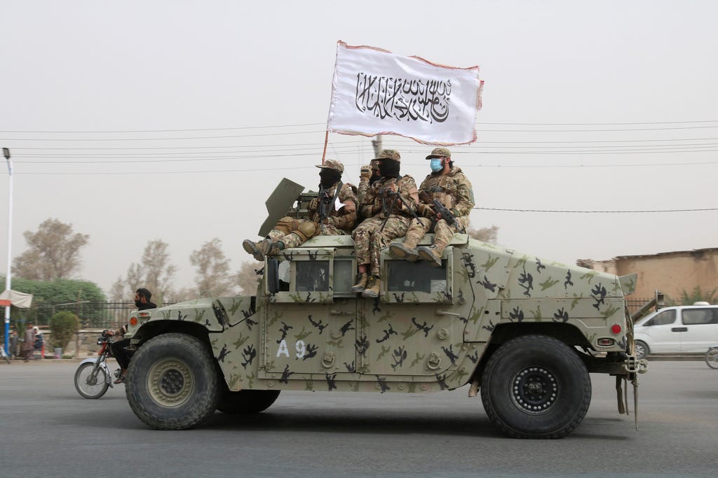 Taliban fighters patrol on the road during a celebration marking the second anniversary of the withdrawal of U.S.-led troops from Afghanistan, in Kandahar, south of Kabul, Afghanistan, Tuesday, Aug. 15, 2023. (Abdul Khaliq—AP)