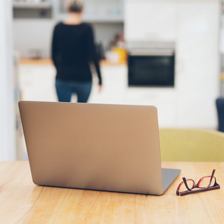 Woman walking away from laptop to get space from her WIP