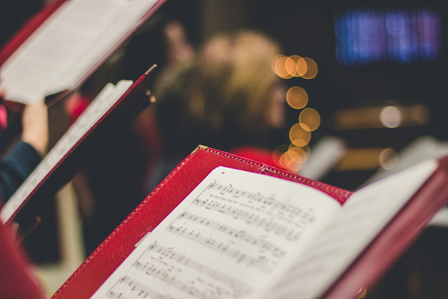 Image of some choral sheet music in some binders in a choir.