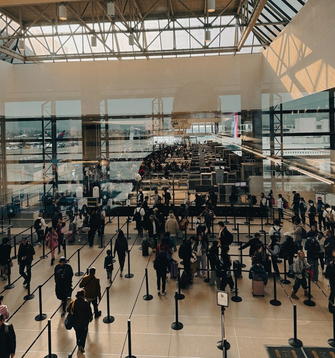 A large group of people walking around a building