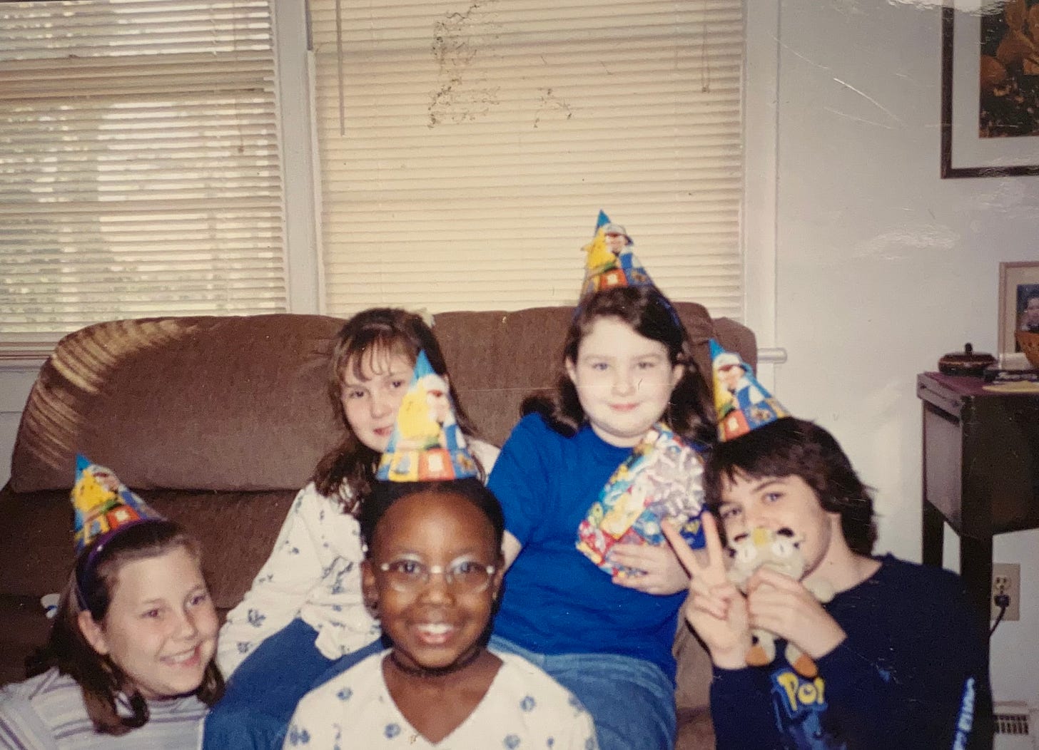 Carrie (back right with the blue Pokémon shirt), her brother, and her friends, come together to celebrate her tenth birthday in December 1999