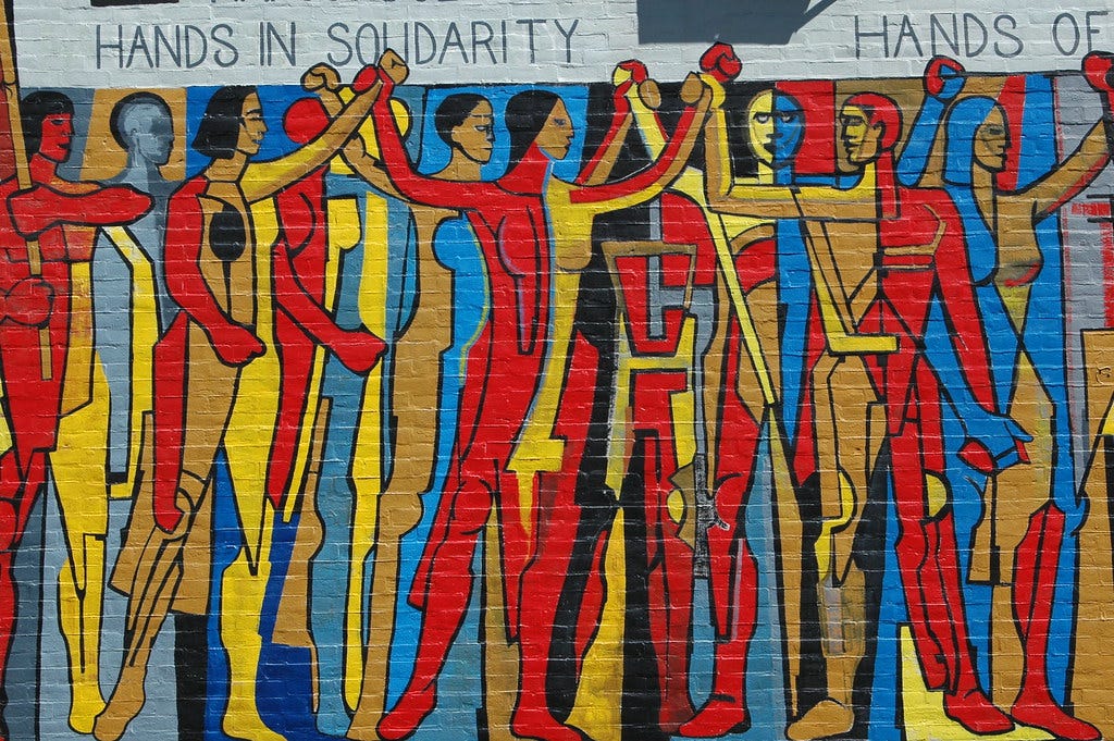 Hands in Solidarity, Hands of Freedom mural on the side of the United Electrical Workers trade union building on West Monroe Street at Ashland Avenue in Chicago, Illinois. Artist Dan Manrique Arias painted this mural in 1997 on the south wall of the United Electrical Workers Union.