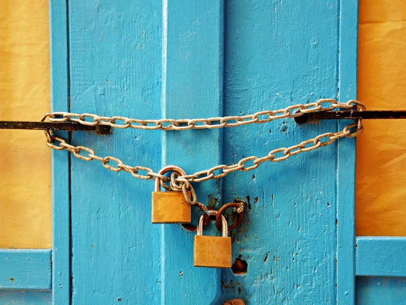 Image from precinbe on Getty Images - picture of a door chained and padlocked shut