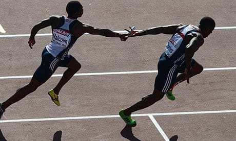 Christian Malcolm attempts to pass on the baton to Dwain Chambers in the men's 4x100m relay