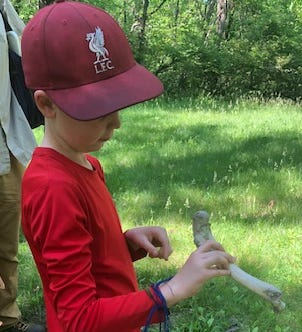 A child holding a bone

Description automatically generated