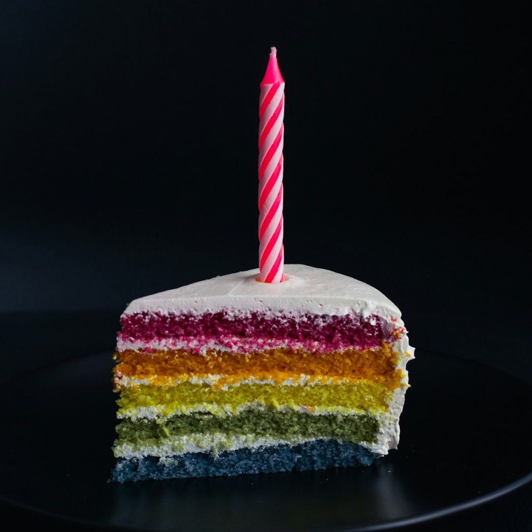 slice of cake with candle on top