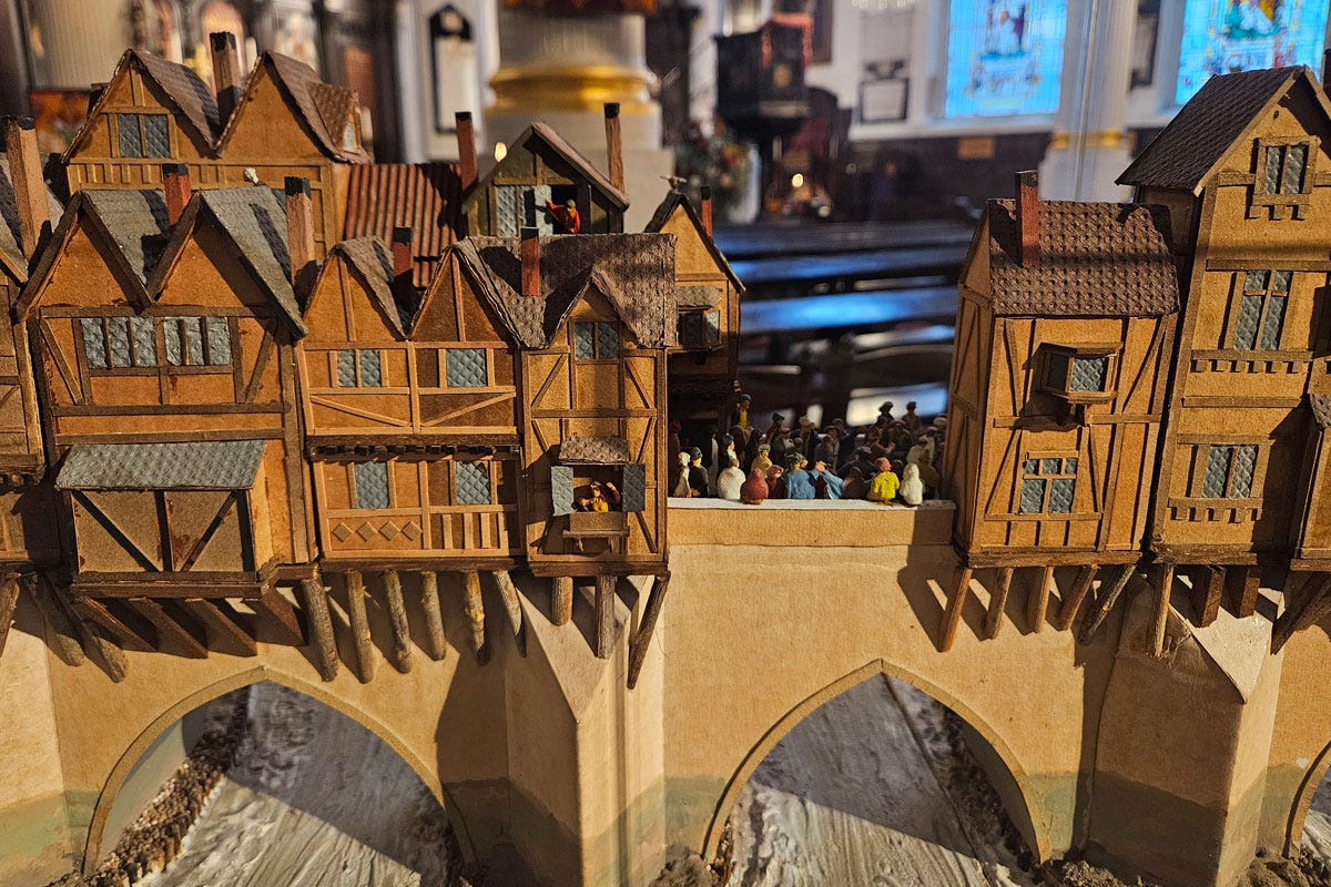 A model of houses built on the side of a bridge