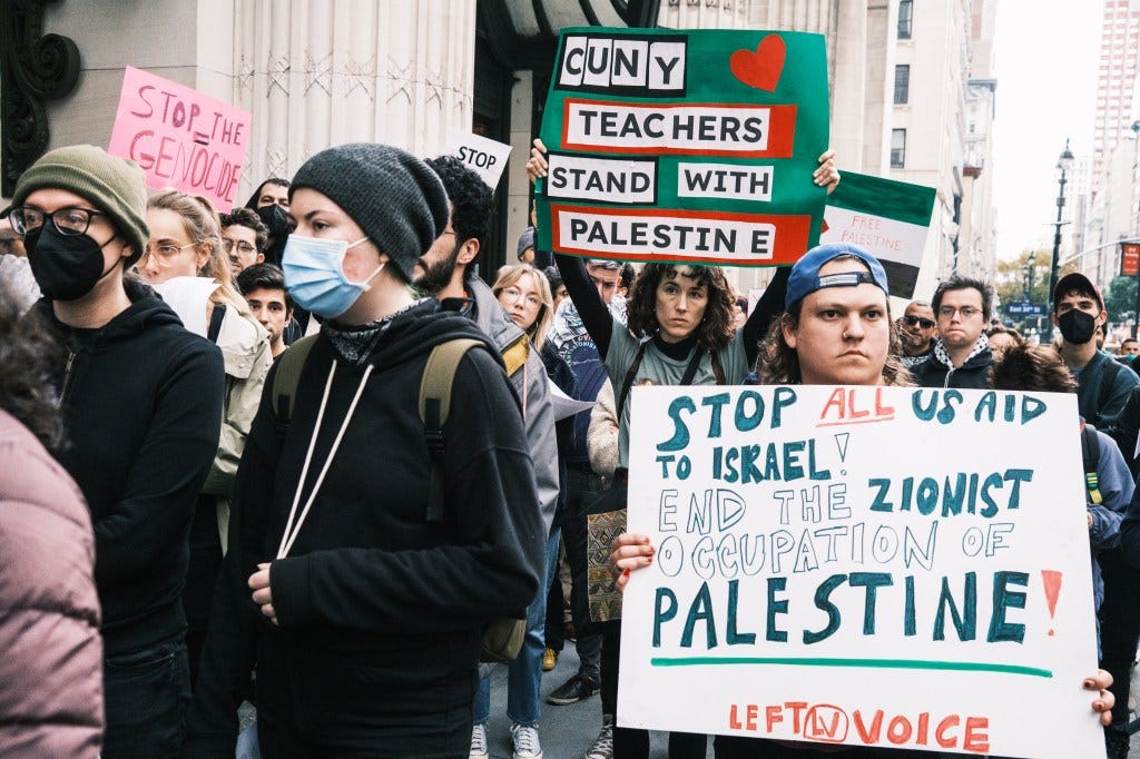 An unidentified female CUNY professor is seen at a rally Wednesday holding a sign reading "CUNY teachers stand with Palestine."