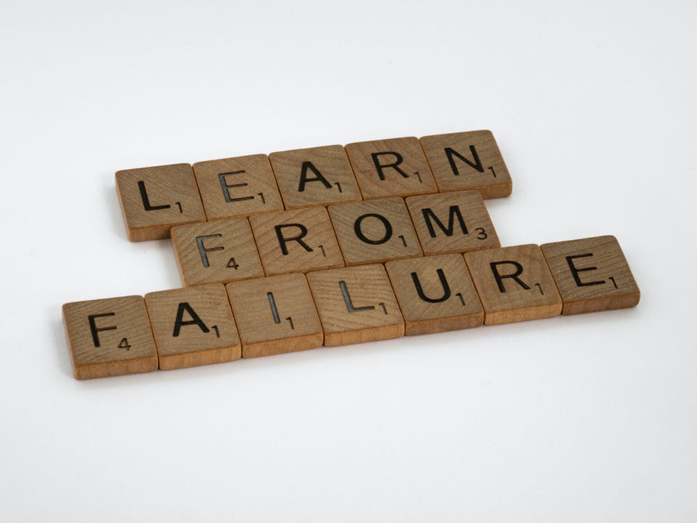 Scrabble tiles that spell out learn from failure