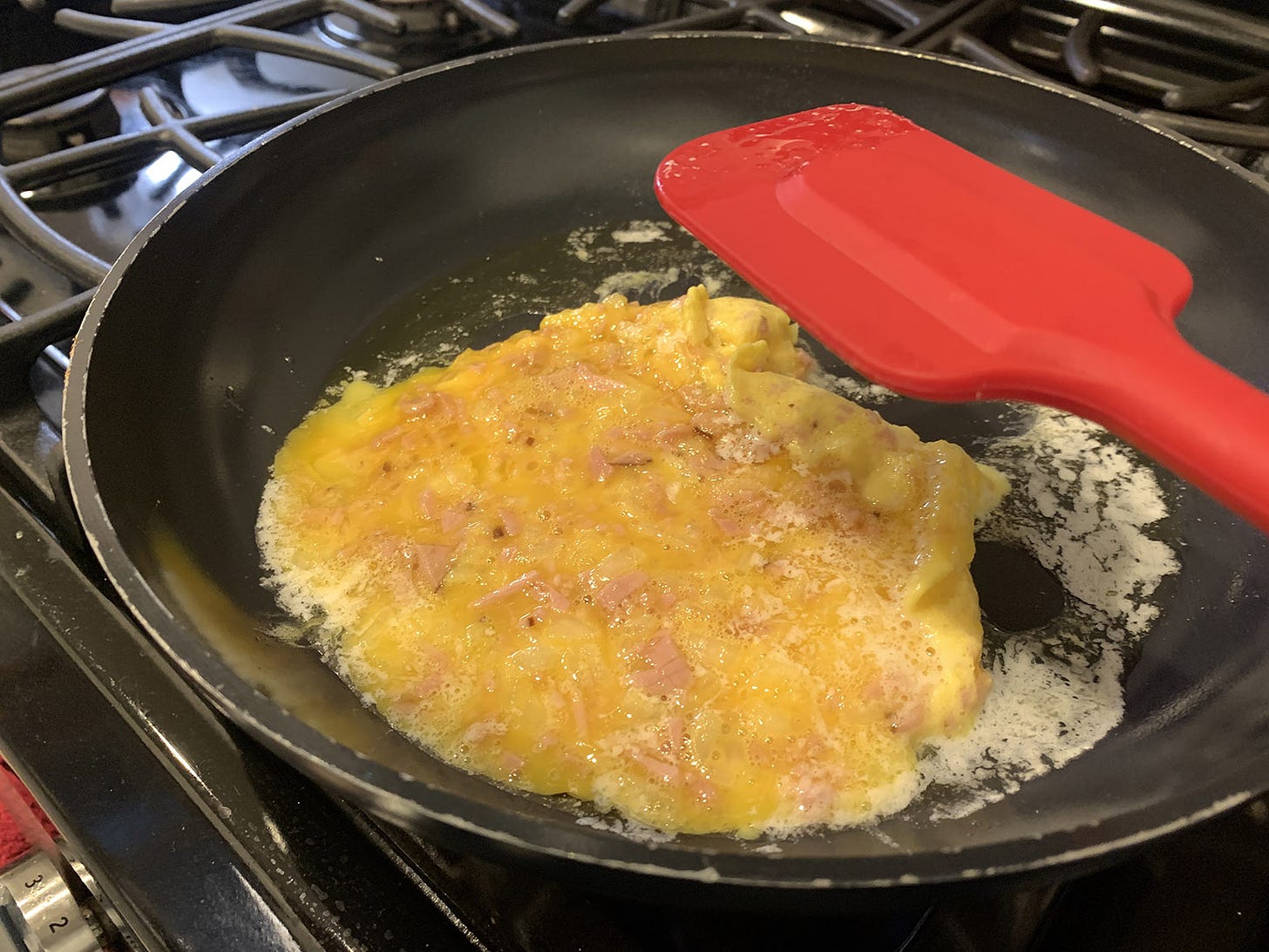 Frying egg ham and onions mixture in nonstick pan