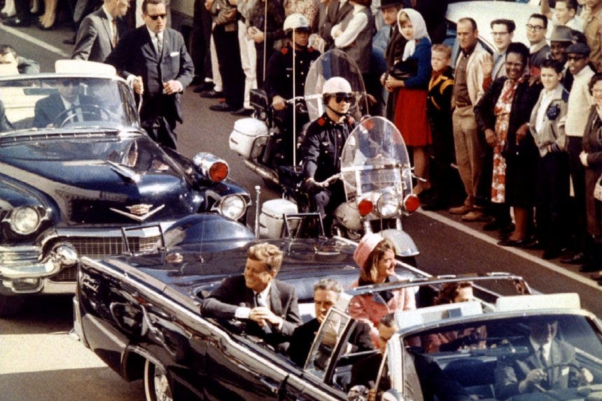 John F Kennedy riding with his wife Jacqueline moments before the assassination
