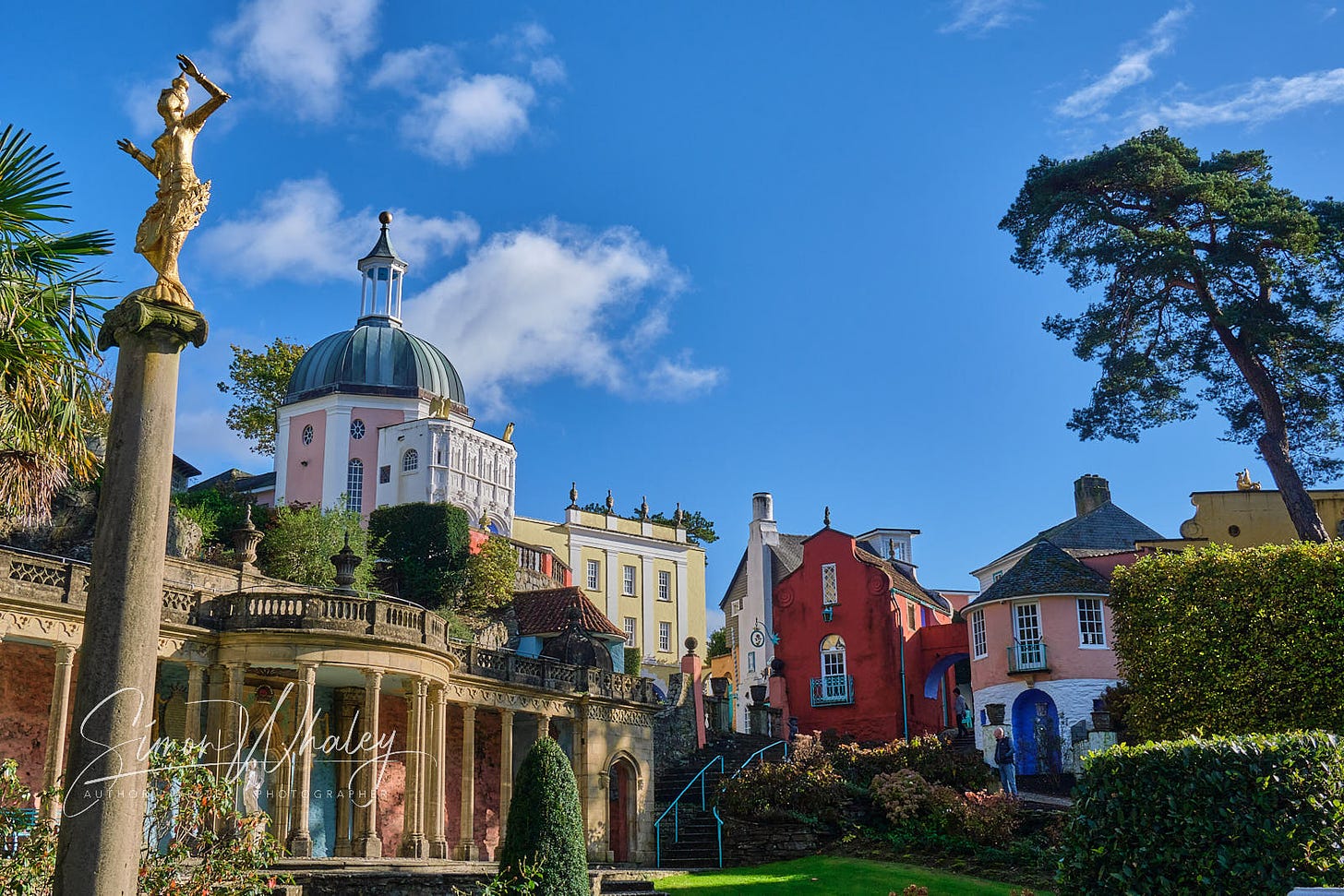 Colourful properties bathed in sunshine of the Italianate village of Portmeirion, North Wales
