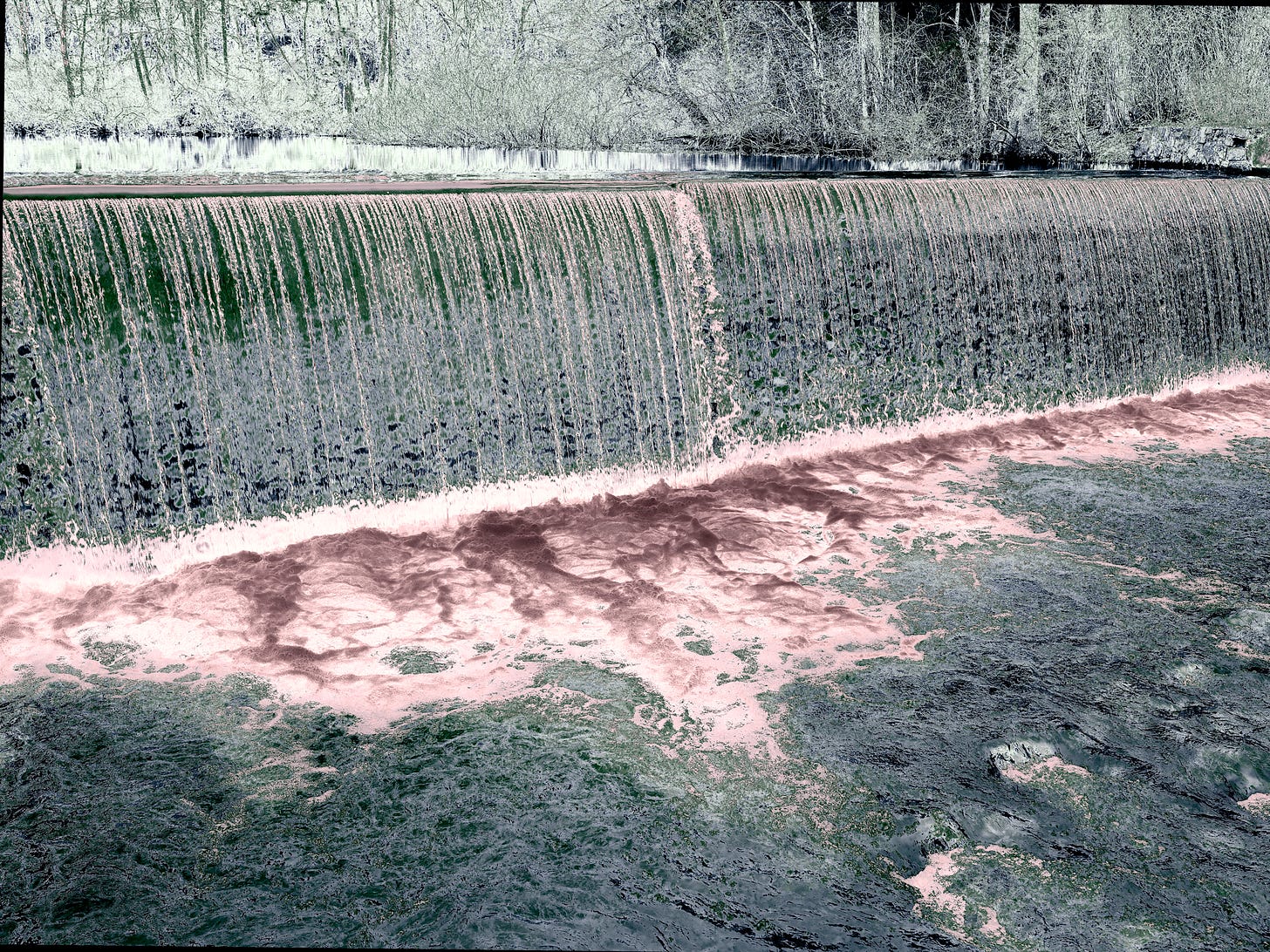 ghostly image of a river spillway in winter