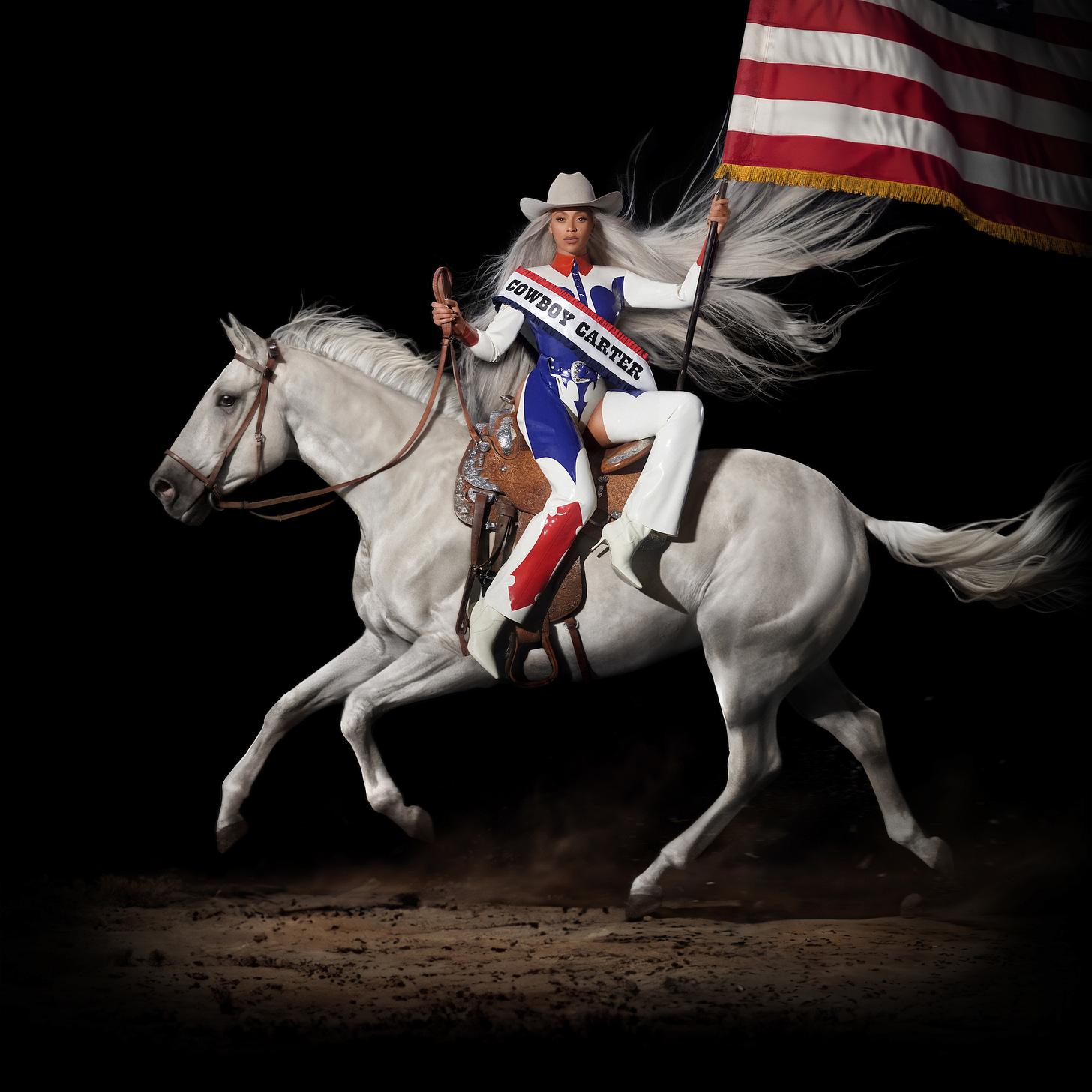 Album cover of Beyoncé's eight studio album, COWBOY CARTER, featuring the singer sitting atop a white horse. She's wearing a white cowboy hat, white cowboy boots and a star-spangled white body suit with a red, white and blue sash that says COWBOY CARTER, while holding the American flag.