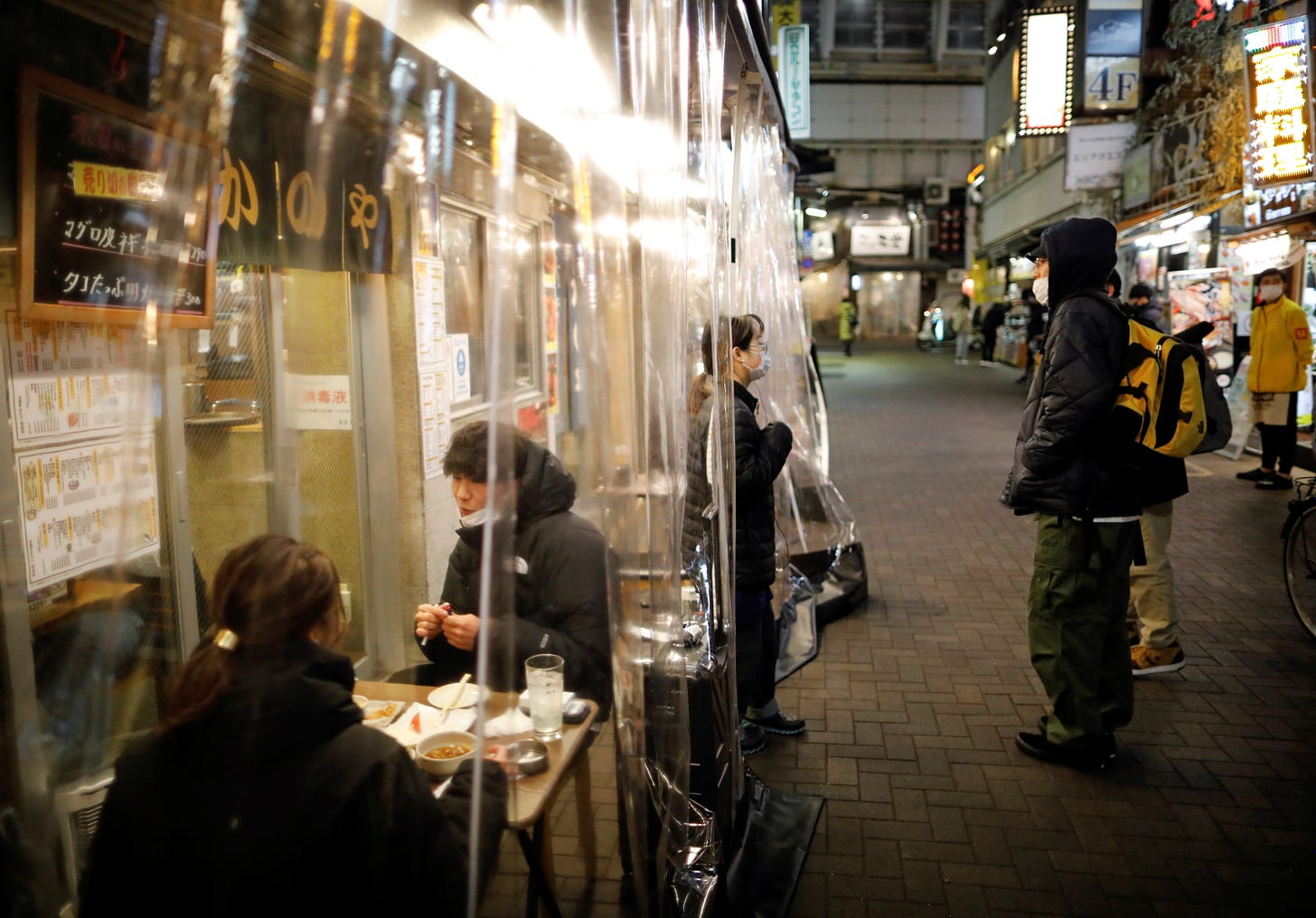 People enjoy drinks and dinner at a Japanese izakaya pub, amid the coronavirus disease (COVID-19) outbreak, in Tokyo