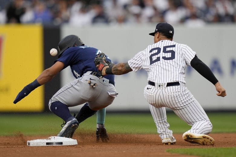 Seattle Mariners&#8217; Julio Rodriguez (44) steals second against New York Yankees second baseman Gleyber Torres (25) in the first inning of a baseball game, Wednesday, June 21, 2023, in New York. (John Minchillo / The Associated Press)