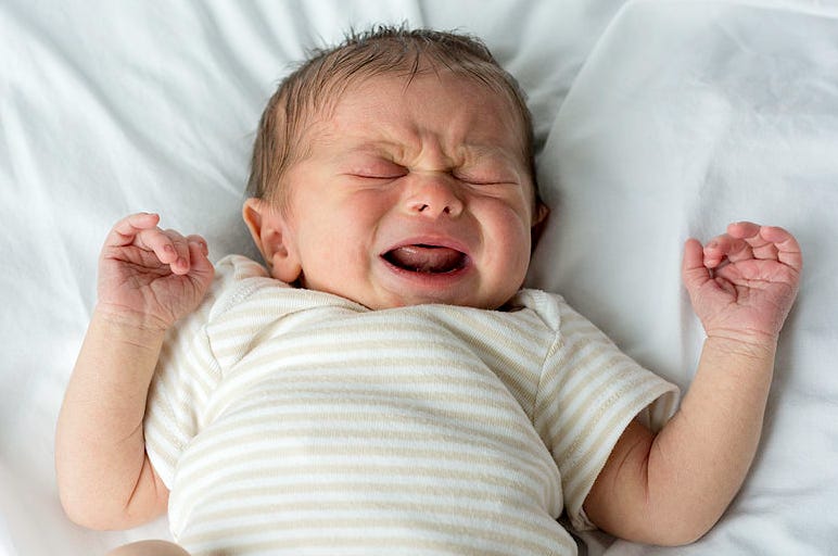 A baby crying in a similar pose to the bat above